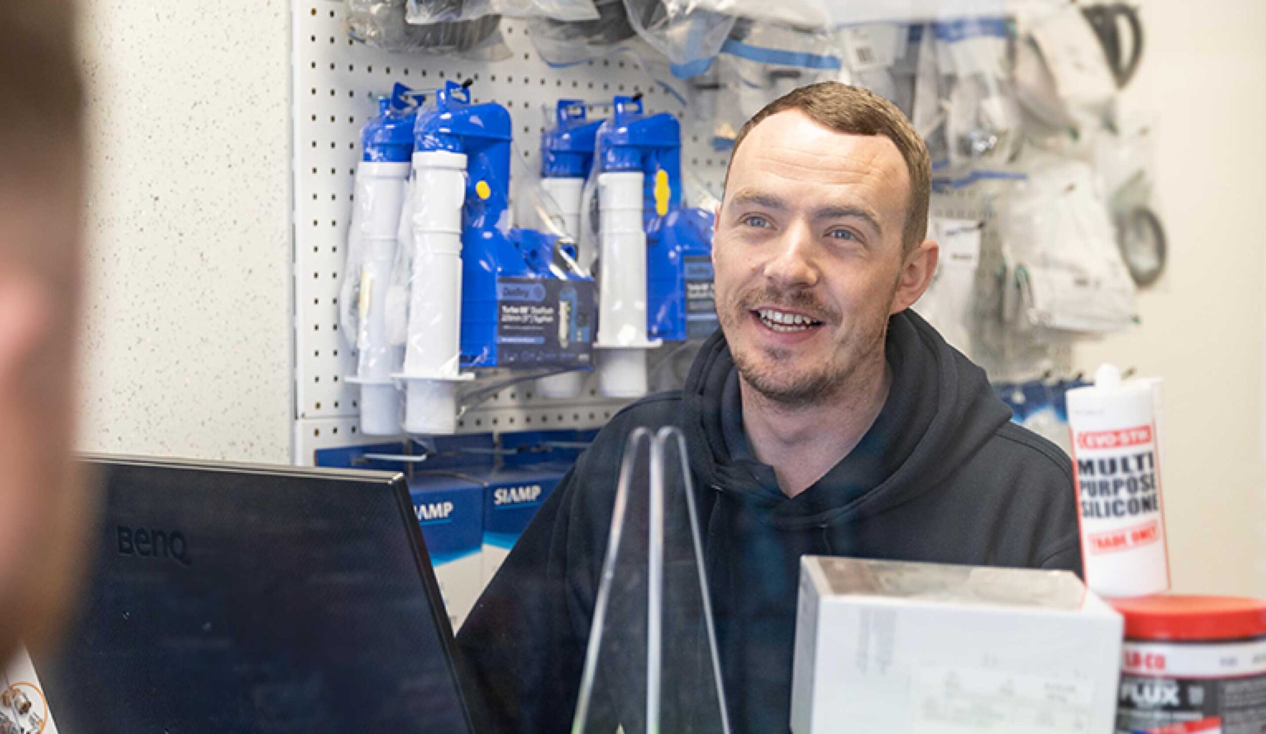 James Hargreaves staff member behind the trade counter serving a customer.